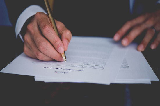 Man Signing A Legal Agreement